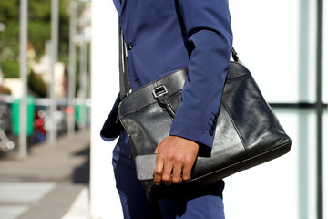 side portrait of black businessman hand holding mobile phone