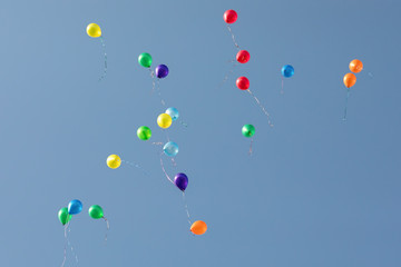 Lots of colorful balloons flying to the blue sky