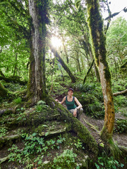 Naklejka na ściany i meble Girl in a dense green rainforest