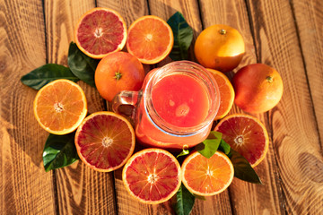 Orange juice of fresh blood oranges. Top view, outdoor shot in the sunshine