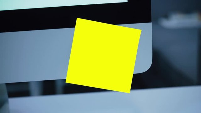 Paper yellow sticker on the monitor. Reminder. List of important cases. A message for an employee, a colleague. Place for the inscription. For tracking. Isolated. Office.