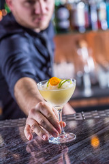 Professional barman making cocktail drink frozen margarita.
