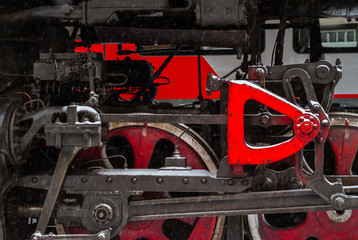 closeup of a steam locomotive wheel with a piston