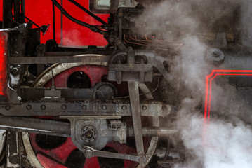 closeup of a steam locomotive wheel with a piston