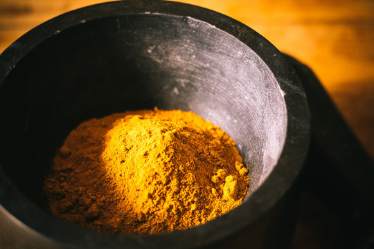 Turmeric Powder In A Mortar And Pestle.