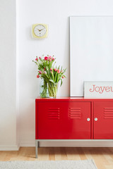 minimalist concept frames flowers and red metal locker