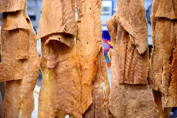 Fillets of dried salted Pirarucu, or Arapaima gigas, the largest freshwater fish of the Amazon River of Brazil, hanging in a fish market