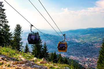 View from the top of the mountain on the city of Sarajevo and funiculars rising up to the highest point of the city. Sarajevo, Bosnia and Herzegovina