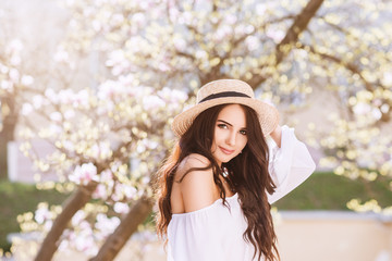 Outdoor close up portrait of young beautiful happy smiling woman with long dark hair, makeup,...