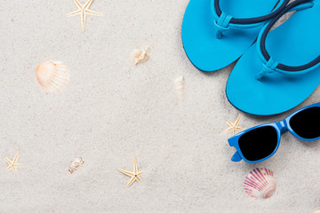Blue flipflops on sandy beach, overhead