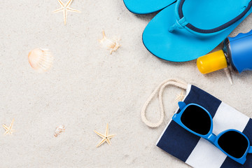 Beach accessory flat lay on sand, summer vacation design