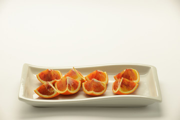 orange wedges arranged on a rectangular plate