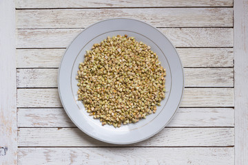 White plate with sprouted buckwheat