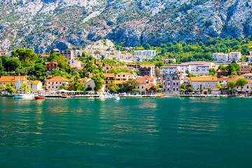 Incredible bright seascape. View of green wooded mountains and blue sea, blue sky and white clouds. Boka Kotorska Bay, Montenegro