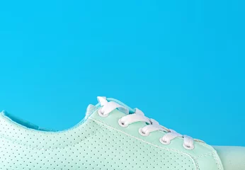 Fotobehang Turquoise sneakers with pastel blue background © Алексей Селянин