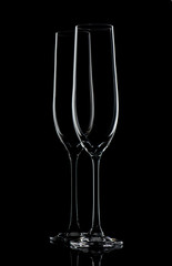Two champagne glasses on black