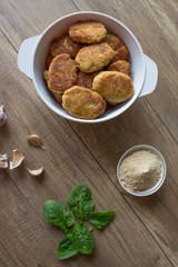 Fried cutlet on wooden table with garlic