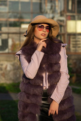 Spring portrait of pretty brunette model wearing trendy outfit posing in soft evening light