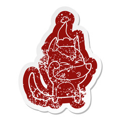 cartoon distressed sticker of a wolf pouting wearing santa hat