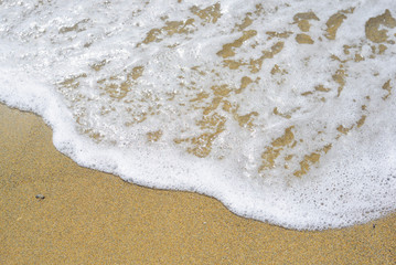 Soft wave of blue ocean on sandy beach. Background