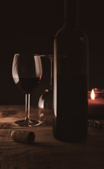 Romantic ambiance wine bottle and wine glasses with candle light
