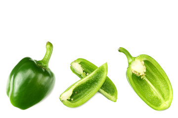 green sweet bell pepper with slices isolated on white background top view