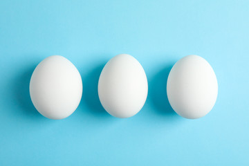 Chicken eggs on color background, space for text