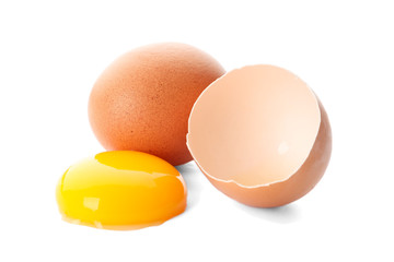 Chicken eggs and half yolk isolated on white background