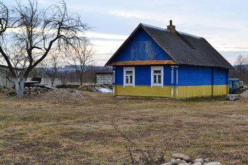 Traditional wooden russian house, rural landscape in winter