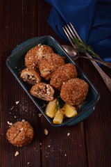 Baked patties in breading with meat in a turquoise rectangular shape. Still life