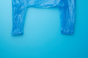 Blue plastic bag on the blue background, recycle concept. Top view.