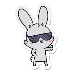 Fototapeta na wymiar sticker of a cute cartoon rabbit wearing sunglasses