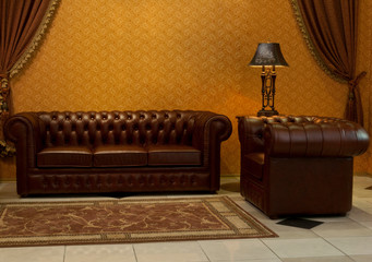 empty interior living room background in warm colors decorated with classic luxury leather furniture