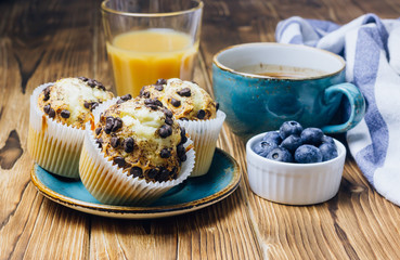 Freshly baked muffins with blueberry on the table.