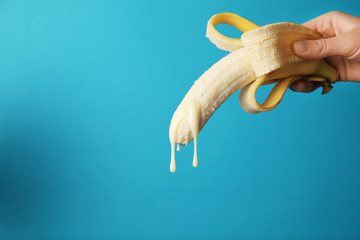 Big banana and drops of condensed milk. Concept of sex, man ejaculation. Sperm and orgasm.