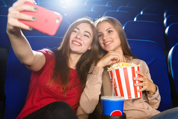 Female friends watching movies at the cinema