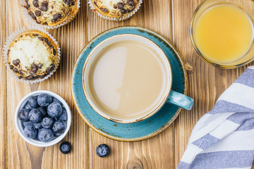 Freshly baked muffins with blueberry on the table.
