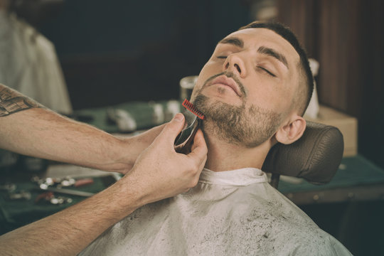 Manly beauty day. Cropped closeup of a young man having his beard shaped in a barbershop