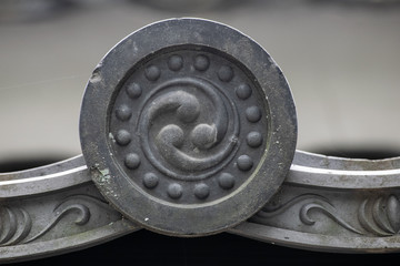 closeup of tomoe on japanese roof tile
