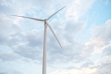 Fototapeta premium Row of wind power generators on blue sky background