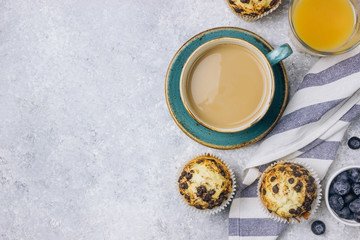 Freshly baked muffins with blueberry on the table.