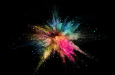 Colored powder explosion on black background. Freeze motion.