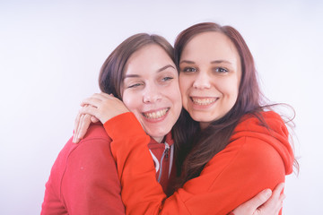 two friends or lesbians on a white background, smiling and laughing in the company of each other. The concept of female friendship and love