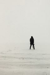man standing on the ice misty morning / simple minimalist photography one person