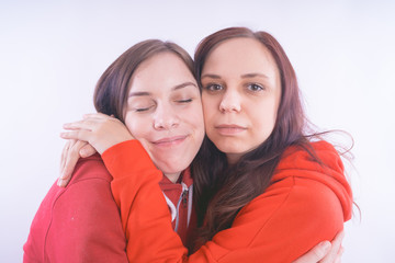 two friends or lesbians on a white background, smiling and laughing in the company of each other. The concept of female friendship and love