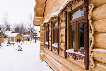 Fototapeta na wymiar Wall of traditional wooden houses with Windows in winter