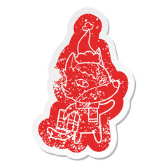 friendly cartoon distressed sticker of a christmas wolf wearing santa hat
