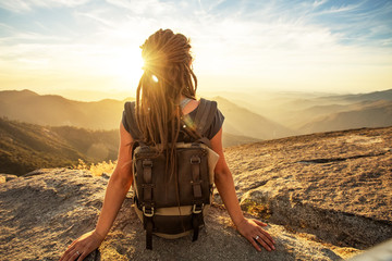Hiker meets the sunset on the Moro rock in Sequoia national park, California, USA.