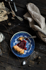 Piece of cherry pie on wooden rustic table