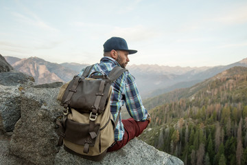 Hiker meets the sunset on the Moro rock in Sequoia national park, California, USA.